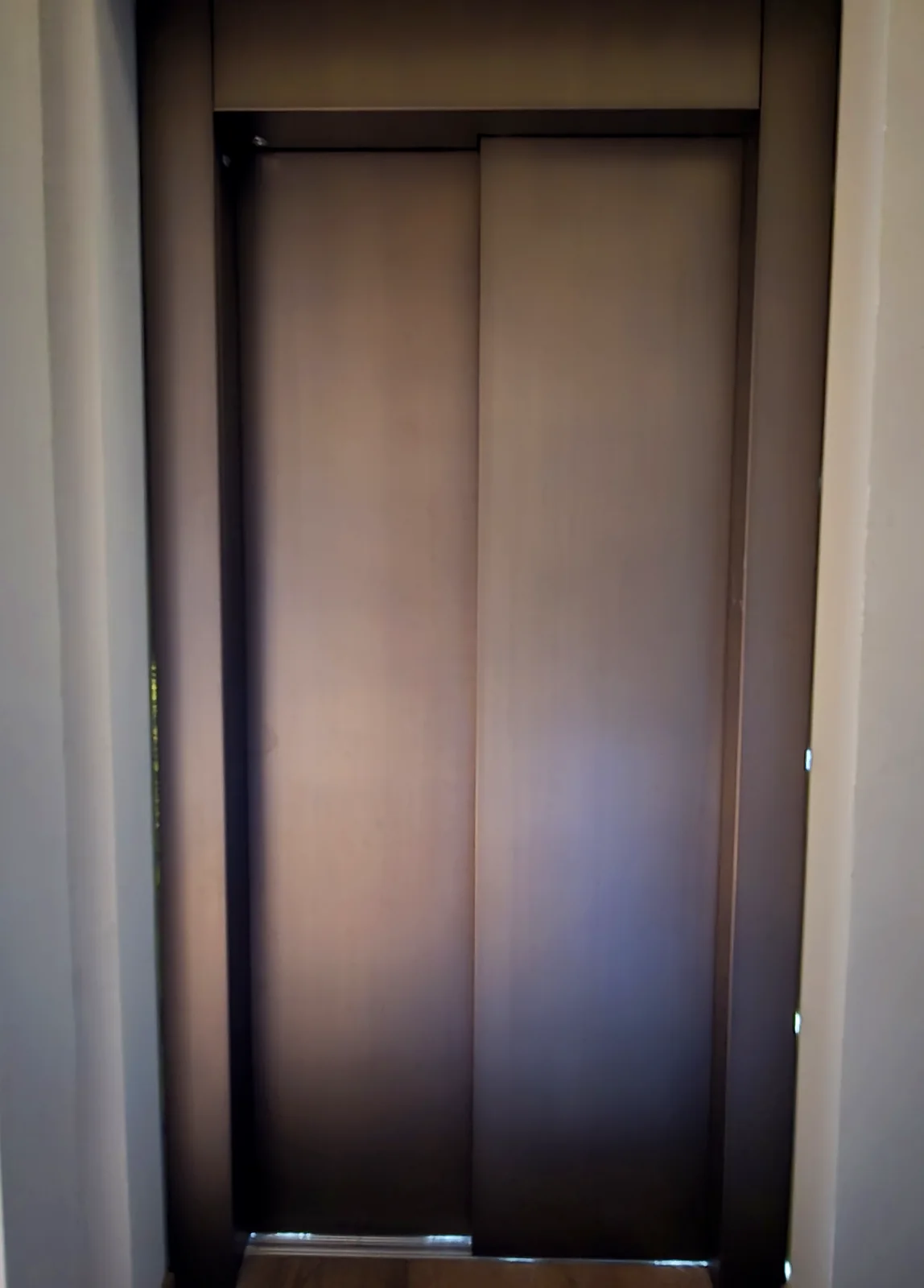 Brass-clad elevator door and frame at Golf Academy Grassau